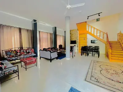 a living room with couches and a dining room at Luxor in Al Karnak