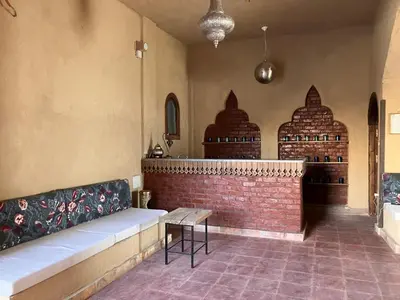a room with a bench and a brick wall at Sultana Palace in ‘Ezbet Abu Ḥabashi