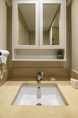 a bathroom with a sink and a mirror at Mangroovy 1BR + Sofa bed • Pool & Beach Access in Hurghada