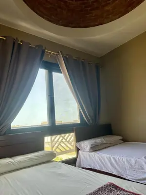 two beds in a room with a window at Luxury Escape in Hurghada, Egypt in Hurghada