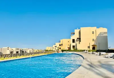 a swimming pool in front of some buildings at Luxury Escape in Hurghada, Egypt in Hurghada