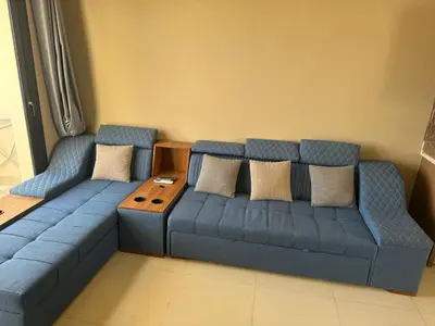 a living room with a blue couch and a table at Luxury Escape in Hurghada, Egypt in Hurghada
