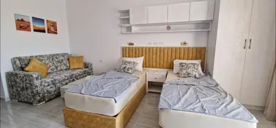 a living room with two beds and a couch at Hurgada New studio in Avenue on Mamsha -private beach&pool in Hurghada