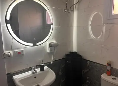 a bathroom with a sink and a mirror at Desert Pearl luxury apartment in Hurghada