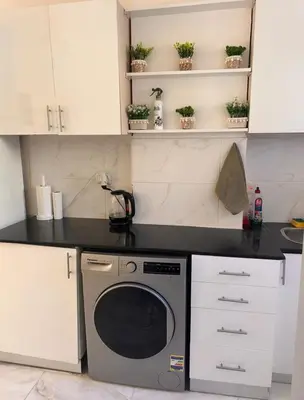 a kitchen with a black counter and a dishwasher at Desert Pearl luxury apartment in Hurghada