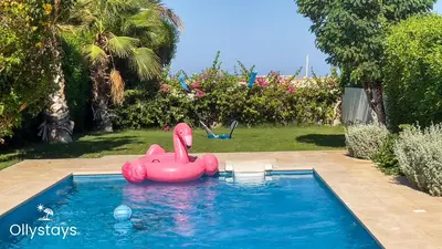 a pink inflatablelatable elephant in a swimming pool at Ollystays Seaview Villa 3BR Heated Pool GYM-Joubal El Gouna in Hurghada