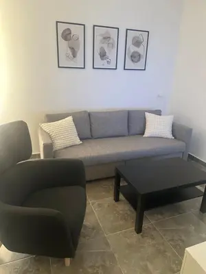a living room with a couch and a chair at Aqua Infinity in Hurghada