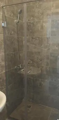 a shower with a glass door in a bathroom at Aqua Infinity in Hurghada