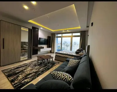 a living room with a couch and a bed at ميراج باي in Hurghada