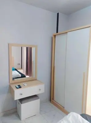 a bedroom with a dresser with a mirror on it at Tiba view in Hurghada