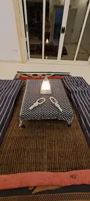 a table with a light on it in a room at Egypt Soul hotel retreat in Luxor