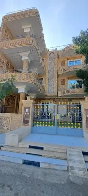 a building with a gate and stairs in front of it at Egypt Soul hotel retreat in Luxor