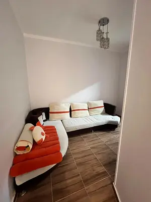 a living room with a bed and a couch at Hurghada Promenade Spacious 1-Bedroom Apartment in Makramia Compound in Hurghada