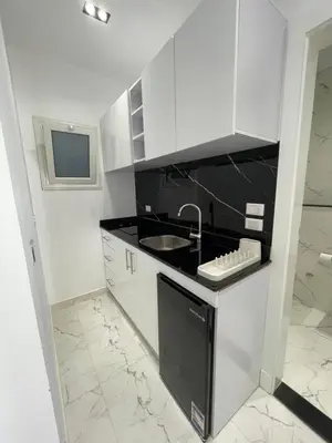 a white kitchen with a sink and a counter at Endless Summer Apartment House W7 in Safaga
