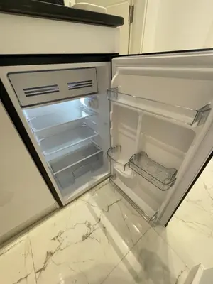 an empty refrigerator with its door open in a kitchen at Endless Summer Apartment House W7 in Safaga