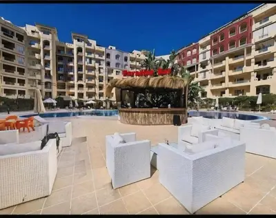 a patio with chairs and a gazebo next to a pool at Hurgada Florenza kamsen with pool view in Arabia area in Hurghada