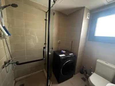 a bathroom with a shower and a washing machine at Private Somabay Villa with Pool in Hurghada