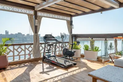 a balcony with a gym on top of a building at HMC Musk Dahabyia in Luxor