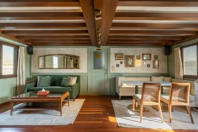 a living room with green furniture and a table at HMC Musk Dahabyia in Luxor