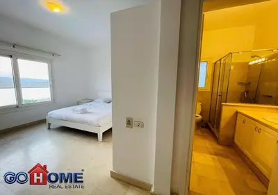 a bedroom with a bed and a bathroom with a sink at Spacious Villa 4 Broom Private Pool V35 at White villa in Hurghada