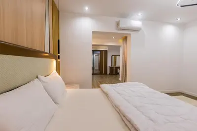a bedroom with a white bed and a hallway at Private Villa AL Mamsha With Private Pool in Hurghada