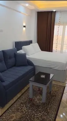 a living room with a couch and a bed at cecelia resort in Hurghada