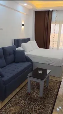 a living room with a couch and a bed at cecelia resort in Hurghada