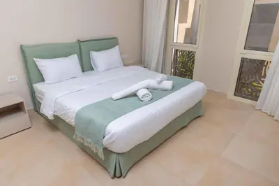 a bedroom with a bed with white towels on it at Hurgada El Gouna Mangroovy 1 bedroom with roof top in Hurghada