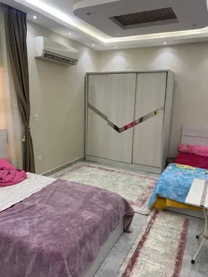 a bedroom with two beds and a large closet at Al fayrouz resort in Hurghada