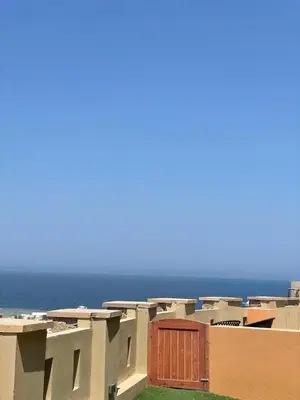 a row of houses with the ocean in the background at Spacious sea view ,1 bedroom apartment in Azzurra Sahl Hasheesh in Hurghada