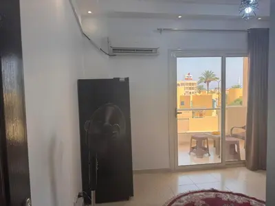a room with a fan in a room with a window at Florenza Khamasin C105 in Hurghada