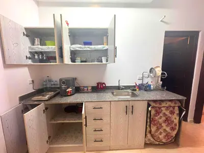 a small kitchen with a sink and a counter at Florenza Khamasin C105 in Hurghada