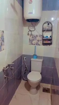 a bathroom with a toilet and a water tank at Wateen guest house in Aswan