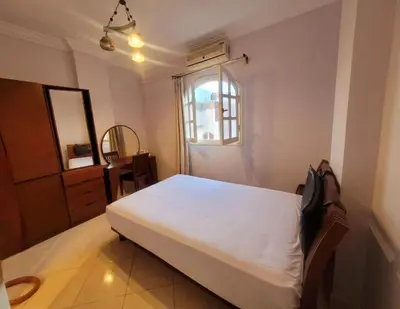 a bedroom with a white bed and a window at Alisra Hurghada Building in Hurghada
