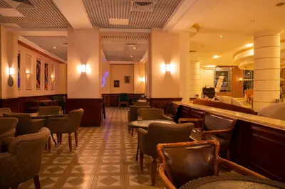 a waiting room with chairs and a bar at Roma Hotel in Hurghada