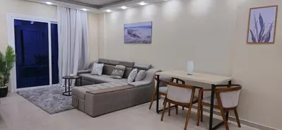 a living room with a couch and a table at Crystal chalet in Hurghada
