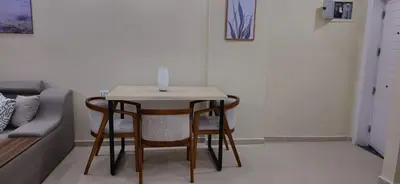 a small table with four chairs and a candle on top at Crystal chalet in Hurghada