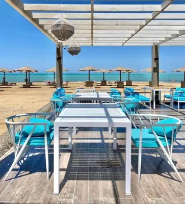 a white table and chairs on the beach at Crystal chalet in Hurghada