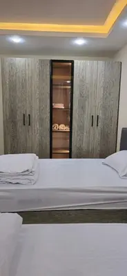a bedroom with a large white bed and a closet at Crystal chalet in Hurghada