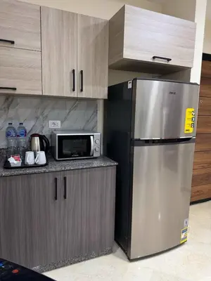 a kitchen with a refrigerator and a microwave at La Quinta Hurghada Pool & Sea View Ground floor in Hurghada