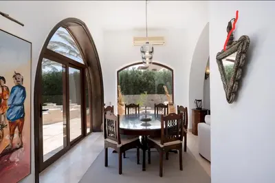 a dining room with a table and chairs and a mirror at Stylish Villas in North Golf El Gouna in Hurghada
