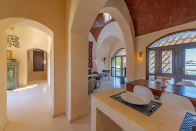 a kitchen and dining room with a table and chairs at Stylish Villas in North Golf El Gouna in Hurghada