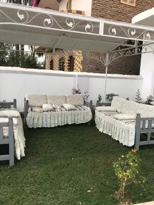a group of beds sitting under an umbrella at Sun Garden Villa in Luxor