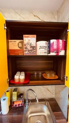 a kitchen counter with a sink and a shelf with books at Modern apartment for rent in Hurghada