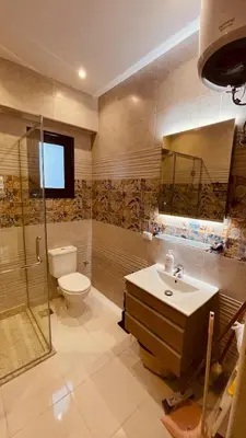 a bathroom with a toilet and a sink and a shower at Modern apartment for rent in Hurghada