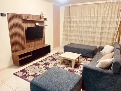 a living room with a couch and a tv at Nesim hights compound in Hurghada