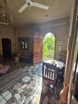 a room with an archway and a wooden door at Villa Harmony Luxor in Luxor