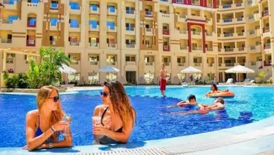 two women sitting in the swimming pool at a hotel at Florenza compound in Hurghada