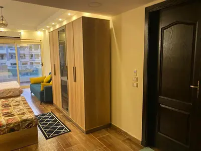 a room with a closet and a couch and a door at Florenza compound in Hurghada