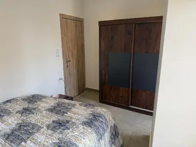 a bedroom with a bed and a large closet at Old Sheraton street apartment in Hurghada
